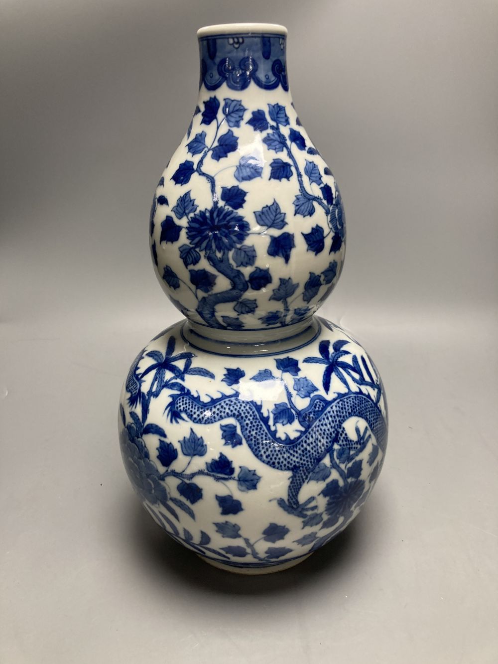 A large Chinese double gourd vase, blue and white dragon design, height 38cm